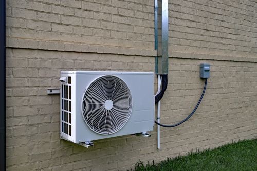 HVAC technician conducting heat pump repairs to ensure efficient heating and cooling performance in a residential home