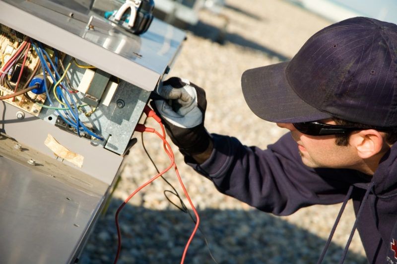 Technician performing energy-efficient HVAC installation, showcasing advanced heating and cooling systems designed for optimal performance and reduced energy consumption